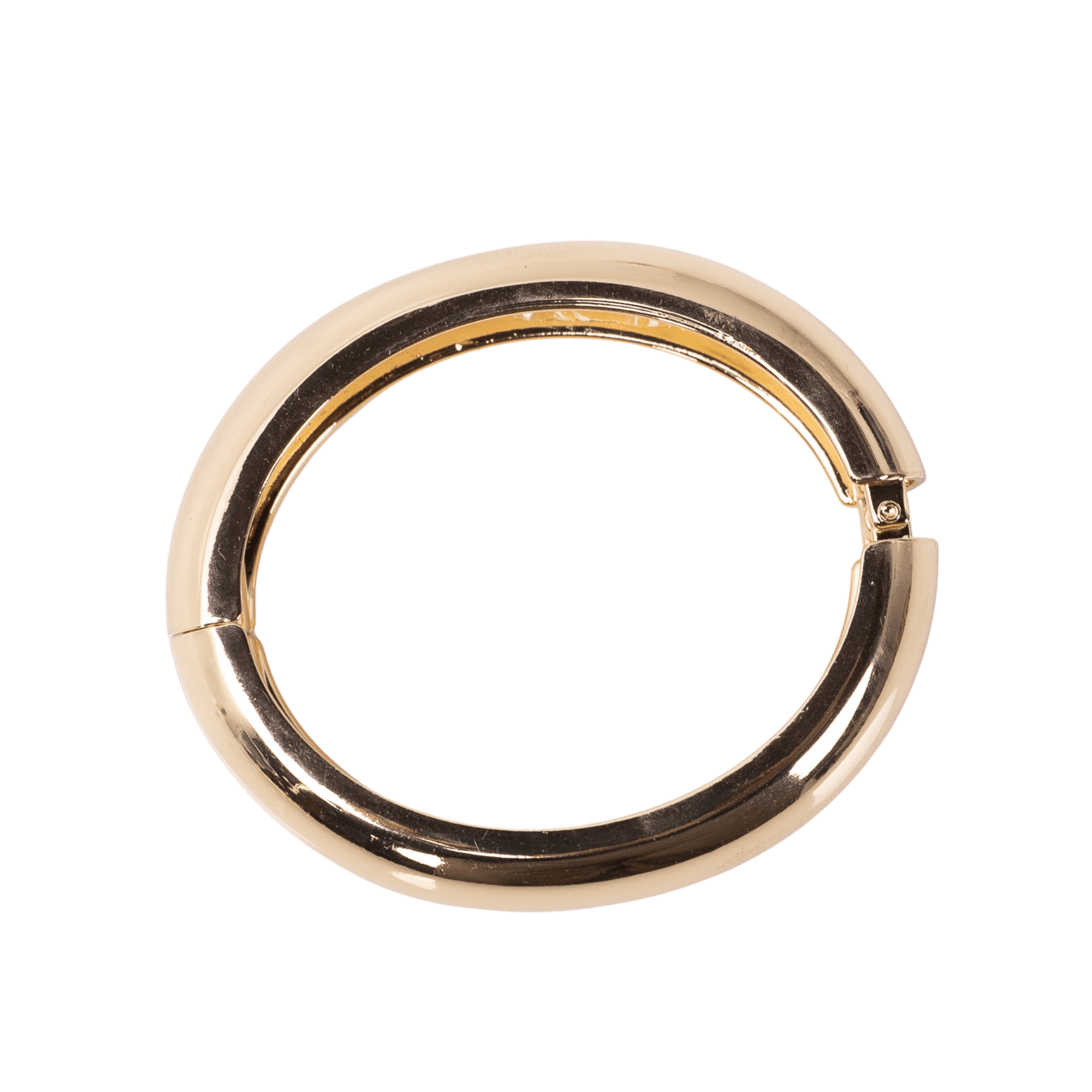 Glossy champagne gold resin bangle bracelet with smooth rounded silhouette on a white background.