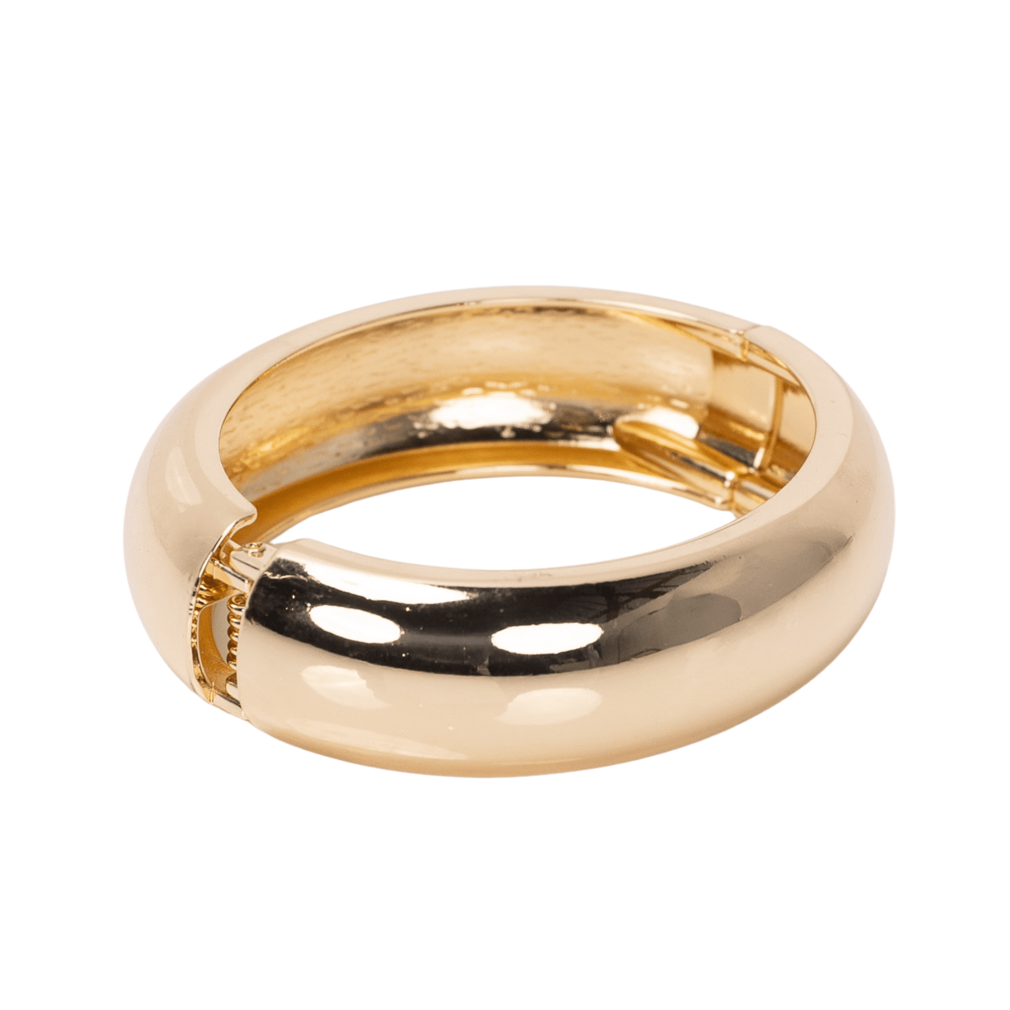 Glossy champagne gold resin bangle bracelet with smooth rounded silhouette on a white background.