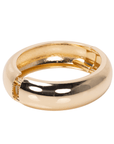 Glossy champagne gold resin bangle bracelet with smooth rounded silhouette on a white background.