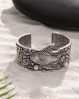 Paloma silver adjustable angelfish cuff bracelet featuring a sculpted fish, pearl accents and intricate coral inspired dimensional metalwork.