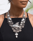 Paloma silver angelfish statement bib necklace featuring sculpted fish, pearl accents, coral inspired details and dimensional silver tone sea motifs.