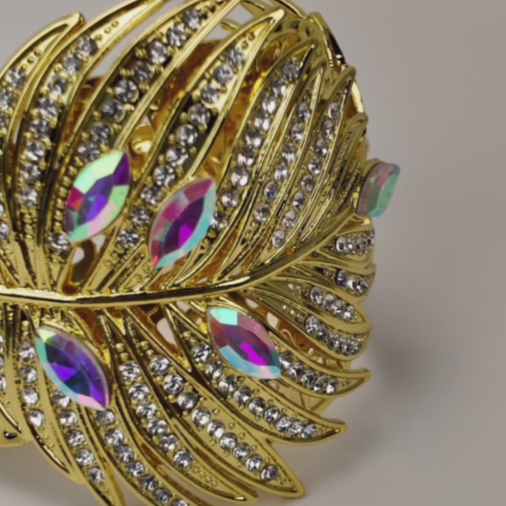 Sassy Jones Calypso Palm Cuff featuring layered gold leaves, clear crystals and rainbow iridescent marquise stones.