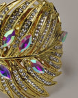 Sassy Jones Calypso Palm Cuff featuring layered gold leaves, clear crystals and rainbow iridescent marquise stones.