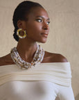 Gold hoop earrings with natural Botswana agate beads in ivory and neutral tones wrapped around a circular hoop design.