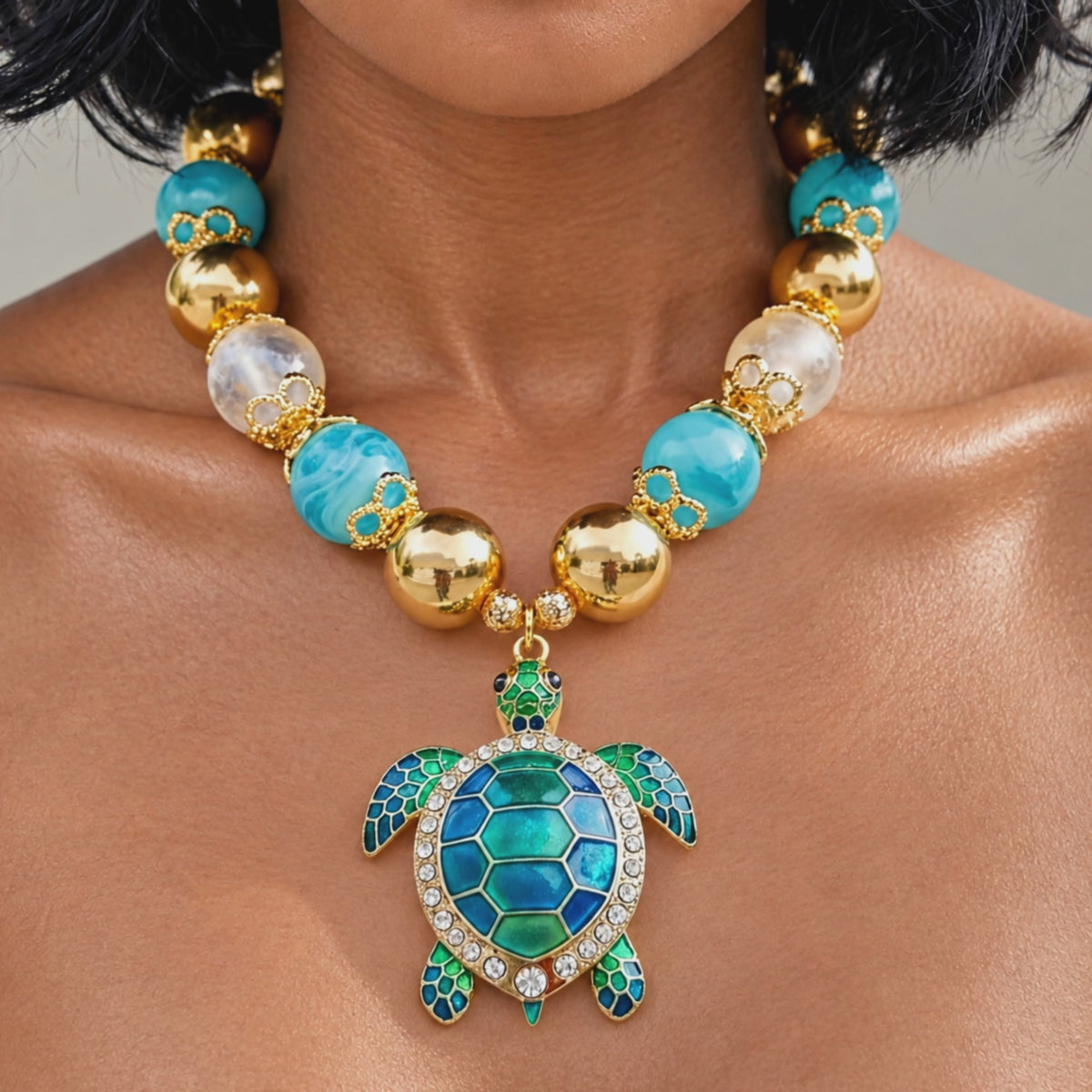 Close up of Soleia Sea Turtle Chunky Chain featuring oversized turquoise and gold beads with a jeweled sea turtle pendant.