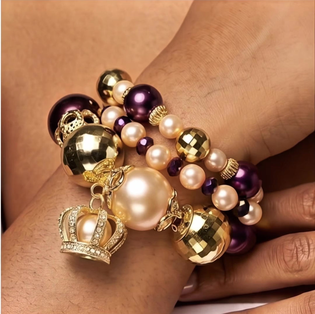  Sassy Jones Reign three-piece bracelet stack featuring champagne pearls, purple beads and 18K gold plated details.