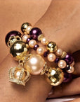  Sassy Jones Reign three-piece bracelet stack featuring champagne pearls, purple beads and 18K gold plated details.