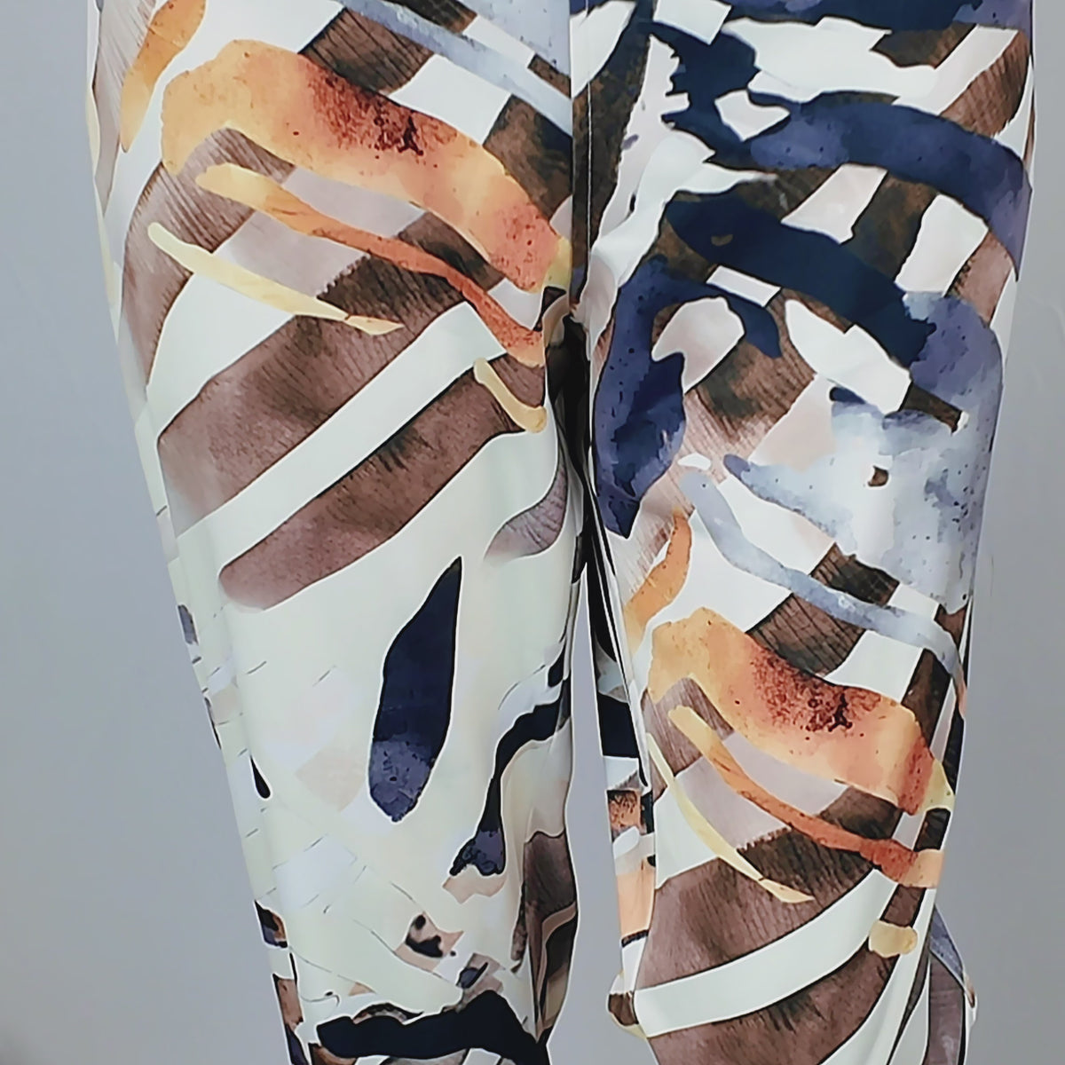 Women's multicolor stretch jogger pant featuring a golden waistband and artistic safari-inspired print.