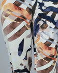 Women's multicolor stretch jogger pant featuring a golden waistband and artistic safari-inspired print.