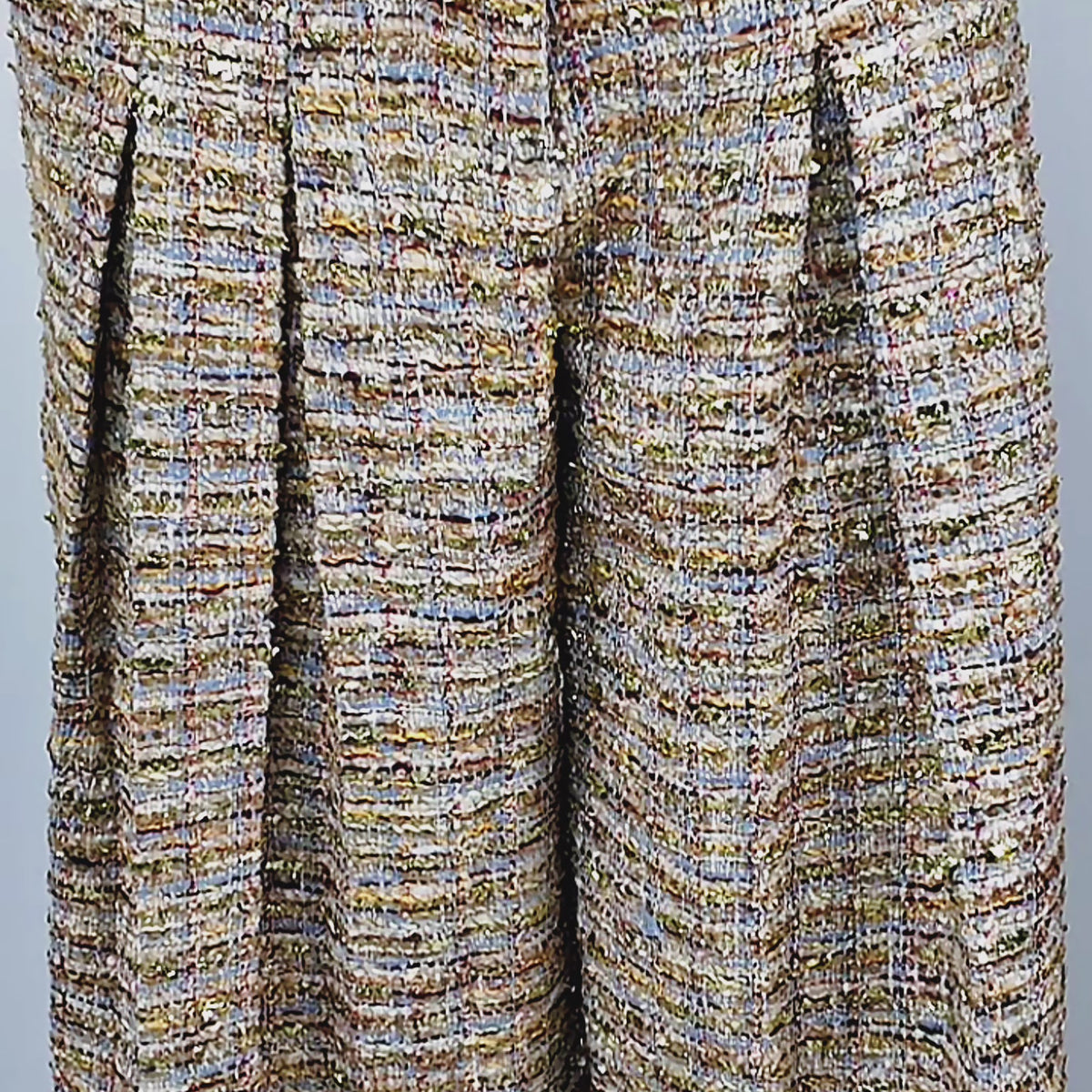 1. The Claire Tweed Trouser shown on model with high waist, tailored pleats, functional side pockets, and floor-length wide legs.