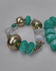 Two piece teal statement bracelet stack featuring chunky marbled beads, clear natural stone and gold accents.