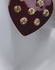 Oversized red heart stud earrings featuring a glossy crimson surface with clear crystals and 18K gold plated detailing.