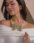 Gold butterfly statement bib necklace with champagne and clear crystals in a radiant oversized design.