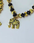 Close up of four coordinating Ibiza stretch bracelets with mixed black and gold faceted beadwork.
