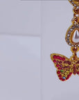 Crystal butterfly dangle earrings featuring multicolored pavé crystals, pear shaped crystal accents, and gold tone detailing.