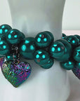 Rainbow Teal Amora bracelet with glossy teal pearl beads and colorful textured heart pendants.