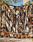 Oversized square scarf featuring mixed animal prints with a contrasting black border and cream dash accents.
