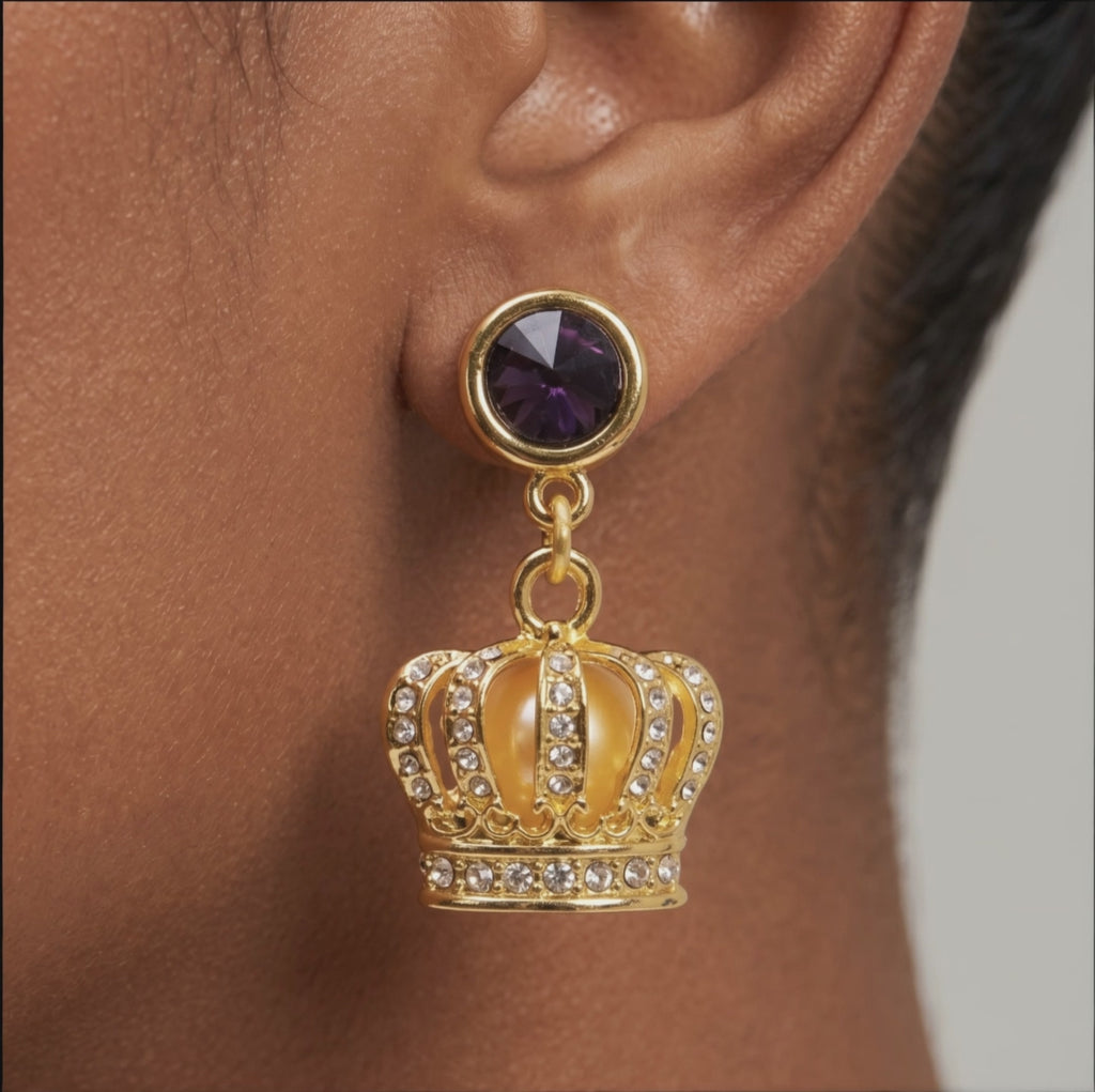Sassy Jones Reign Pavé Crown Earrings featuring purple accents, champagne centers and ornate gold detailing.