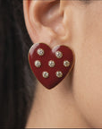 Oversized red heart stud earrings featuring a glossy crimson surface with clear crystals and 18K gold plated detailing.