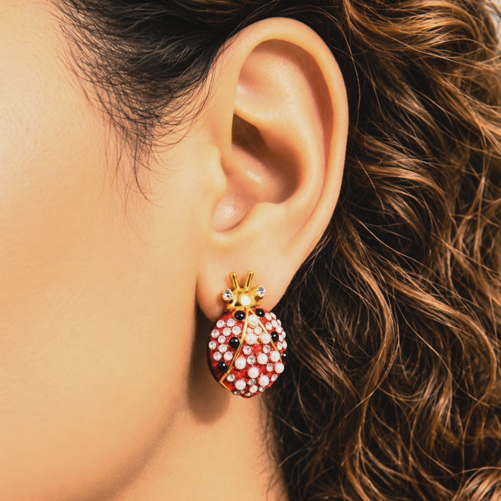 Dainty jeweled ladybug earrings featuring red, black and white detailing with pearls and sparkling crystal accents.