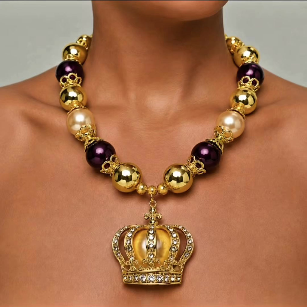 Sassy Jones Reign necklace with champagne pearl beads, metallic gold beads and crystal embellished crown pendant.
