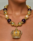 Sassy Jones Reign necklace with champagne pearl beads, metallic gold beads and crystal embellished crown pendant.