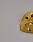  Colorful heart stud earrings featuring a yellow finish, red, blue and green crystals, and polished gold detailing.