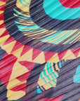 Woman wearing the Imani Afrikaan maxi dress with dramatic pleated sleeves, collared neckline, and flowing printed skirt.