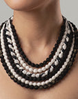 Close view of Kenza Cloth Bead Bib featuring mixed black and white textile covered beads. 