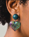 Colorful heart statement earrings with glossy teal glass pearl studs and textured iridescent rainbow drops.