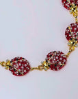 Red ladybug statement chain featuring sparkling crystals, pearl-like accents and Gold tone finish details.