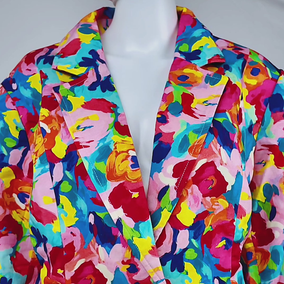 Sassy Jones Summer Garden Blazer with structured shoulders, notched lapels, front pockets, and colorful floral print.