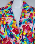 Sassy Jones Summer Garden Blazer with structured shoulders, notched lapels, front pockets, and colorful floral print.