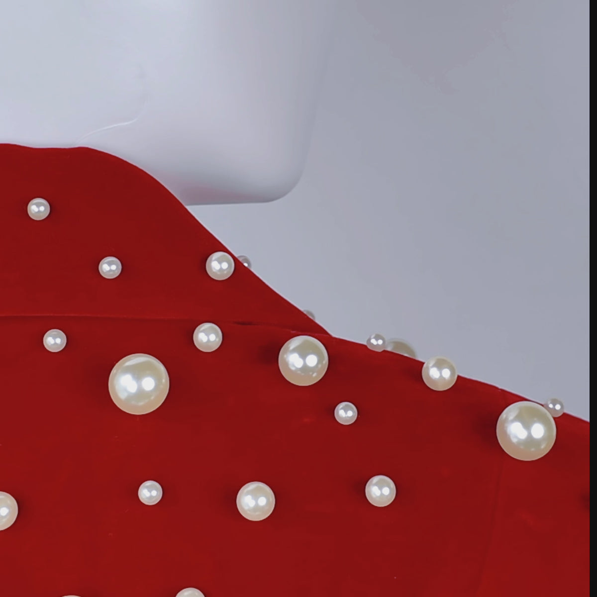 Red statement blazer featuring mixed size pearls, structured lapels and polished cuff button details.