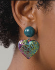 Colorful heart statement earrings with glossy teal glass pearl studs and textured iridescent rainbow drops.