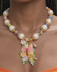 Sassy Jones tropical parrot statement necklace with colorful floral pendant and pearl inspired beads