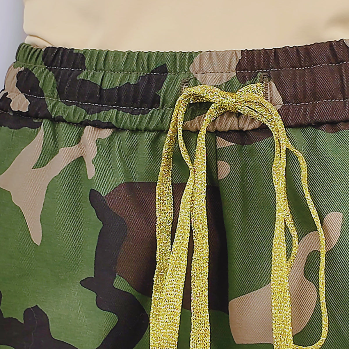 Full length view of Sassy Jones Milan camouflage pants with colorful sequin stripes along each leg.