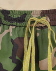 Full length view of Sassy Jones Milan camouflage pants with colorful sequin stripes along each leg.