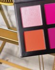 Color Bloom Blush Palette featuring six colorful blush shades in pink, peach, lilac, and berry tones beside model with glowing radiant skin