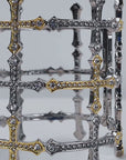 Trinity 18K Cross Sparkling Cuff featuring alternating gold and silver cross motifs with crystal detailing.    Woman wearing the Trinity Cross Sparkling Cuff with sculptural mixed metal crosses and shimmering crystals.    Sassy Jones Trinity cuff bracelet featuring interconnected gold and silver tone crosses embellished with crystals. 
Close up of mixed metal statement cuff featuring gold cross accents surrounded by silver cross motifs.   Trinity statement bracelet featuring an openwork cross design with