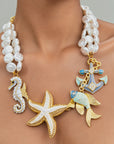 Harbor Grace nautical necklace with white baroque pearls, hand painted ocean charms and 18k gold plated accents.
