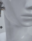 Trinity 18K Cross Sparkling Earrings featuring three cascading crystal crosses in gold and silver finishes.   Woman wearing Trinity statement earrings with layered gold and silver crystal cross motifs.   Sassy Jones Trinity drop earrings featuring three sparkling crosses in contrasting mixed metal finishes.   Close up of crystal cross earrings with a silver cross stud, gold center cross and dangling silver cross.   Trinity faith inspired earrings featuring cascading crystal embellished crosses in gold and s