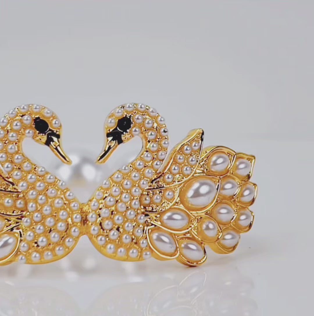 Luxury pearl bracelet featuring two jeweled swans with sparkling crystal bodies and dimensional pearl feather detailing