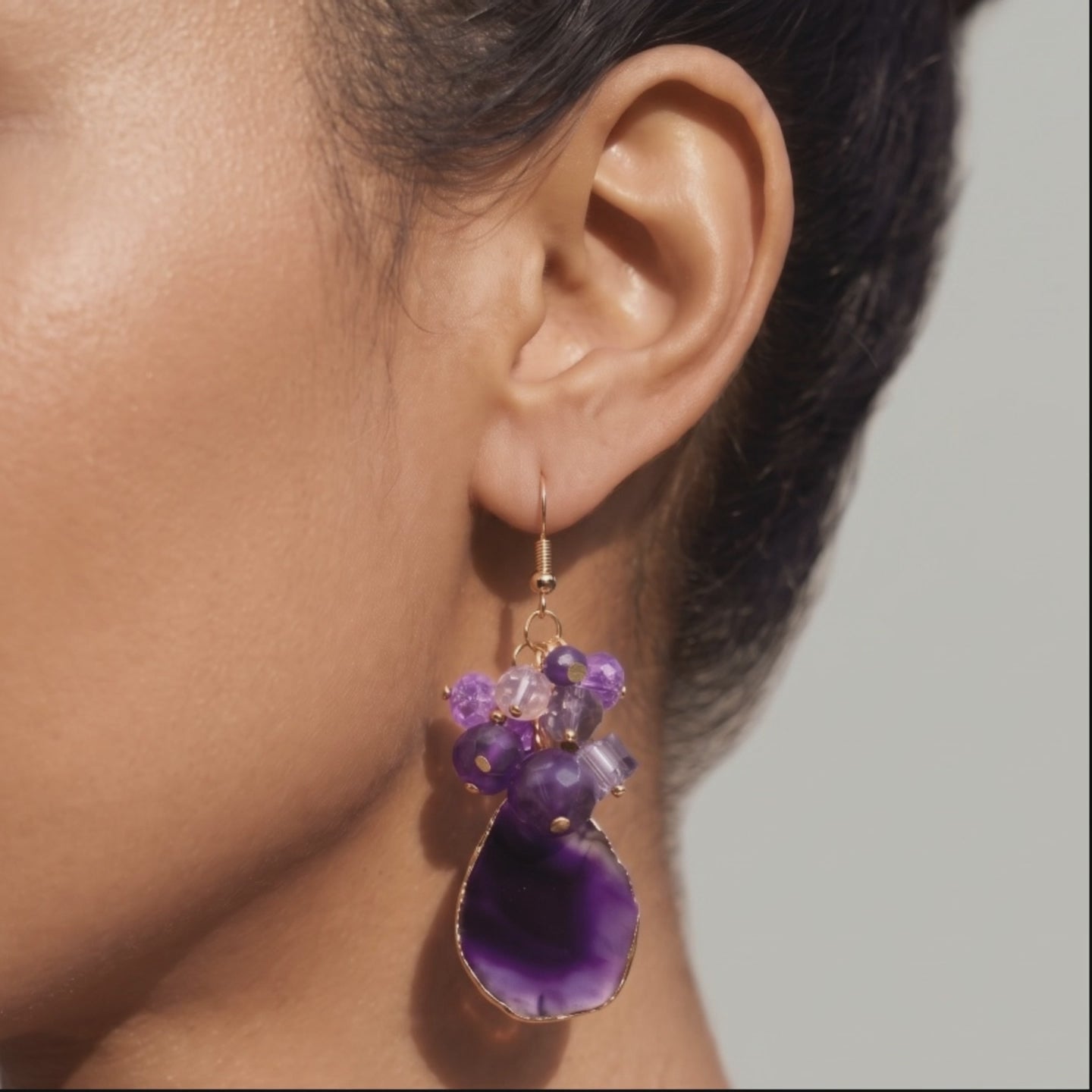 Natural purple agate earrings featuring organic stone patterns, purple bead clusters and fish hook closures.