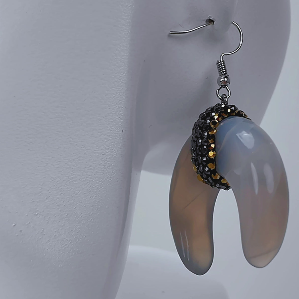 Zuma crescent dangle earrings featuring organic shell variation, crystal detailing, and delicate hook ear wires.