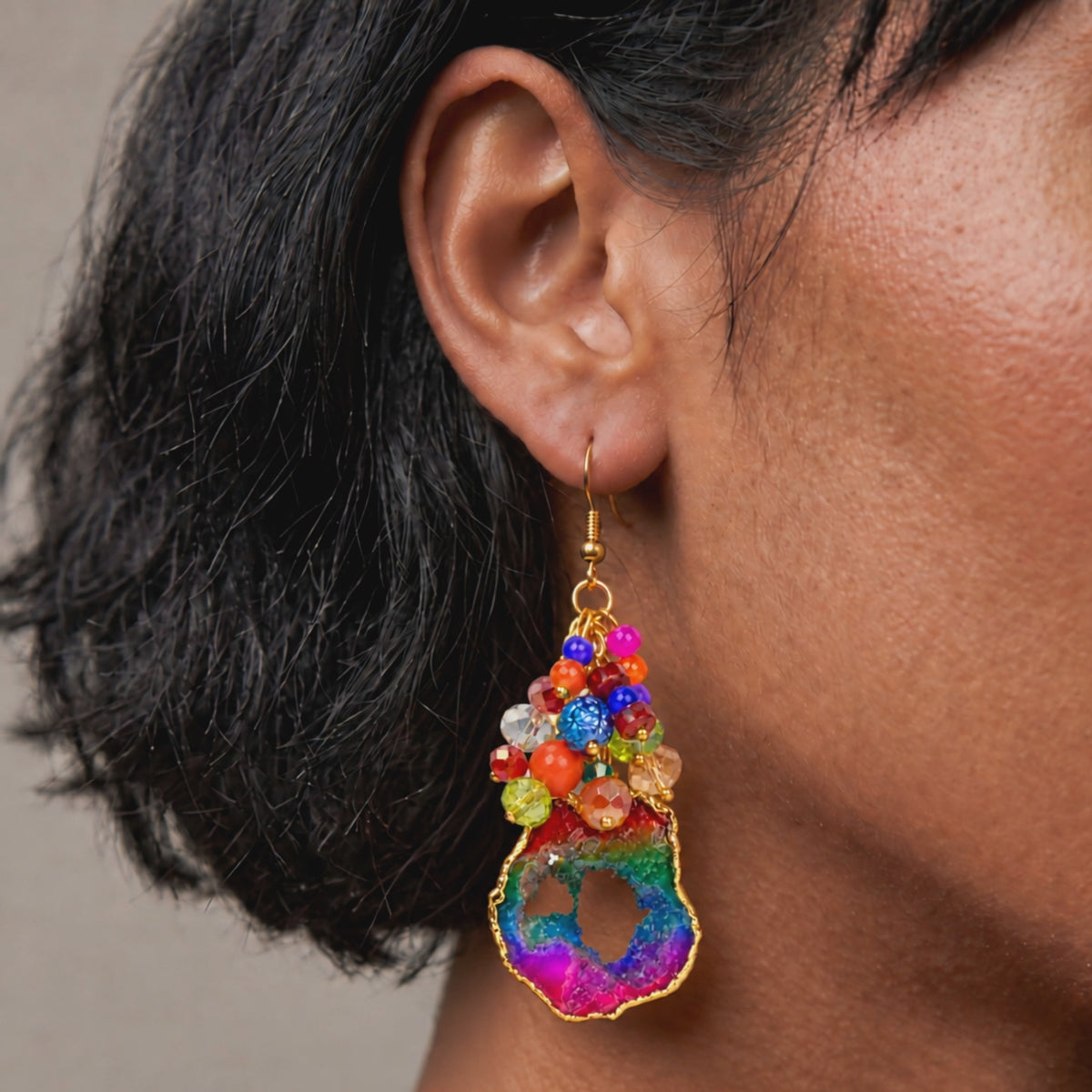 Multicolor statement earrings with raw agate drops, faceted rainbow beads, and gold details.