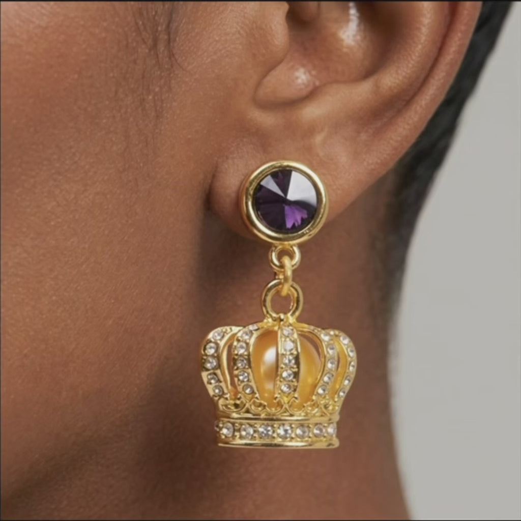 Sassy Jones Reign Pavé Crown Earrings featuring purple accents, champagne centers and ornate gold detailing.