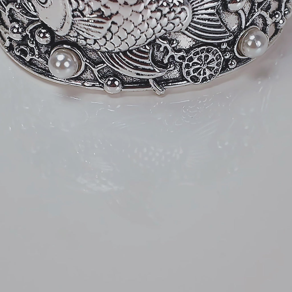 Adjustable silver cuff bracelet with central angelfish motif, dimensional bubbles and luminous pearl accents.