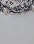 Adjustable silver cuff bracelet with central angelfish motif, dimensional bubbles and luminous pearl accents.