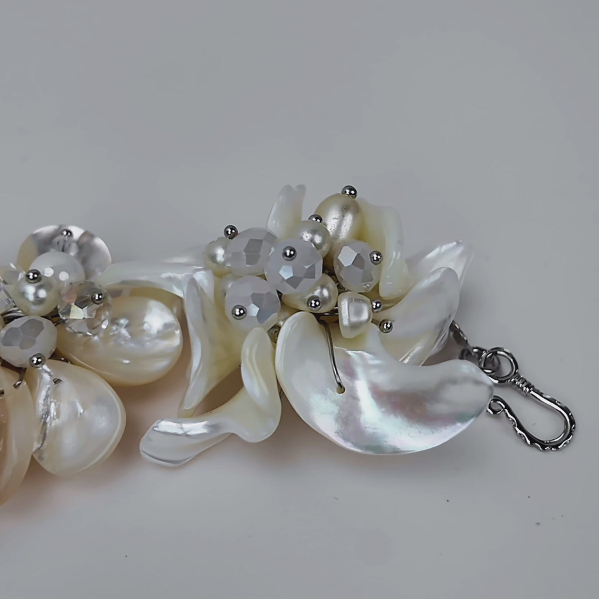 vory floral bracelet featuring dimensional natural shell blossoms, luminous pearls and intricate handcrafted detailing.